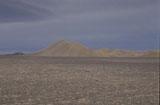 Poušť Atacama je díky rozmanitosti nerostů různorodě zbarvená. Tato bílá skála čněla z šedivého písku jako jehlan.